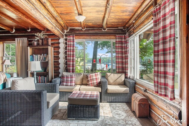 sunroom / solarium featuring beam ceiling and wood ceiling