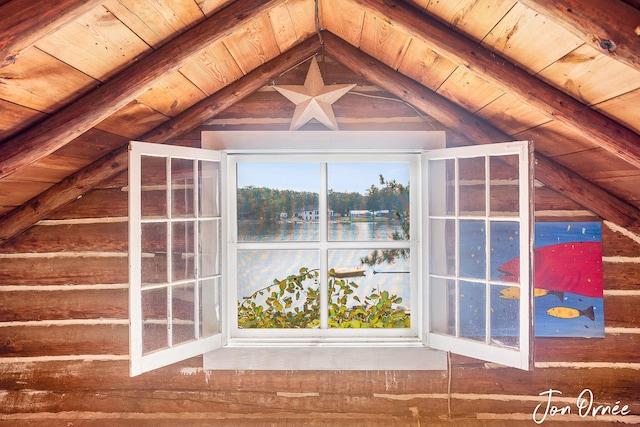 interior space with a water view, a wealth of natural light, lofted ceiling with beams, and wooden ceiling