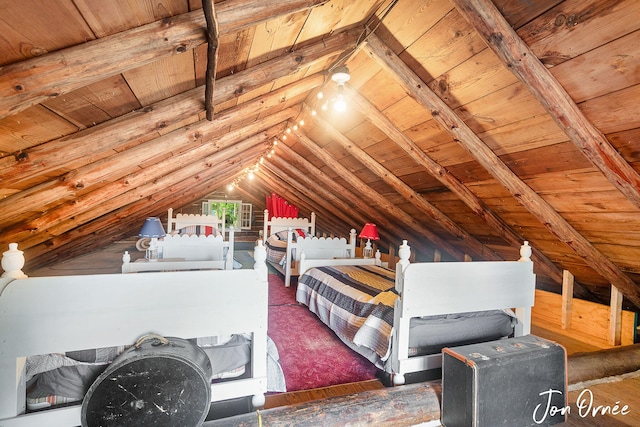 bedroom with vaulted ceiling with beams and wood ceiling