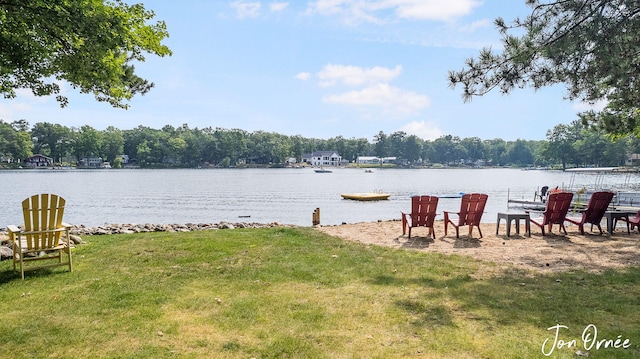 exterior space featuring a water view and a lawn