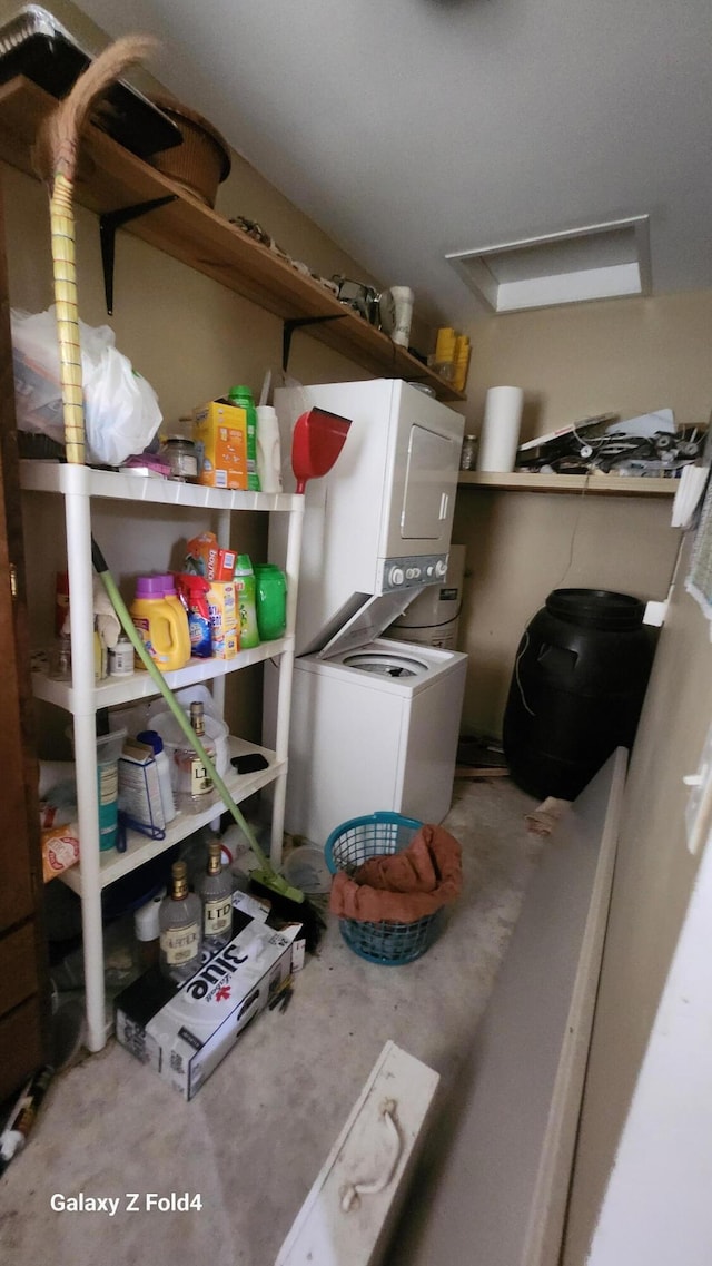 clothes washing area featuring stacked washer / drying machine