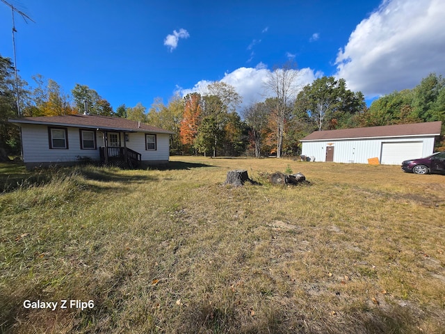 view of yard with an outdoor structure and a garage