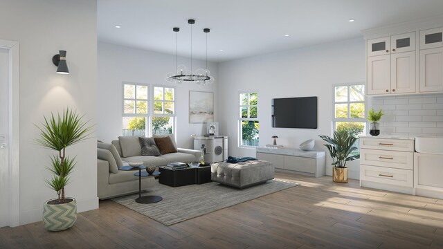 living room featuring a notable chandelier, a healthy amount of sunlight, and light wood-type flooring