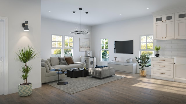 living room featuring plenty of natural light, an inviting chandelier, and light wood-type flooring