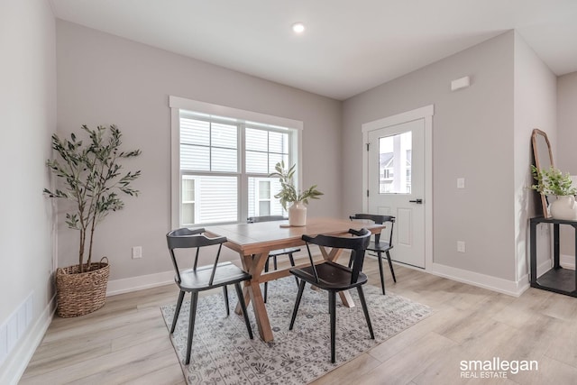 dining space with light hardwood / wood-style flooring