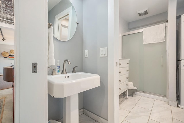 bathroom with walk in shower and tile patterned flooring