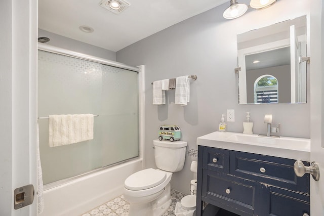 bathroom with visible vents, toilet, vanity, and shower / bath combination with glass door