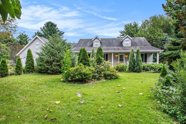 cape cod home with a front yard