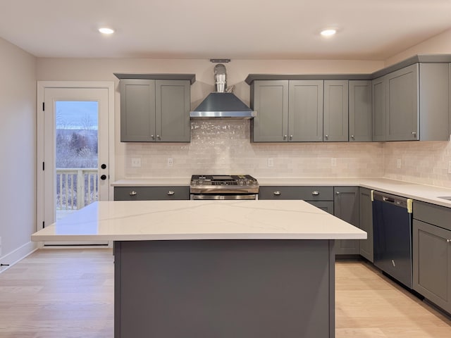 kitchen with stainless steel stove, gray cabinets, black dishwasher, and a kitchen island