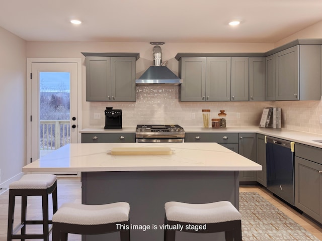 kitchen featuring gray cabinets, a kitchen island, black dishwasher, a kitchen bar, and stainless steel range oven