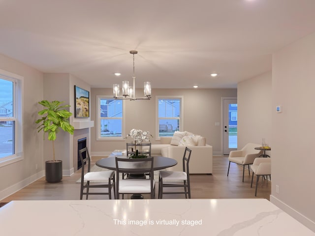 dining area featuring a notable chandelier and light wood-type flooring