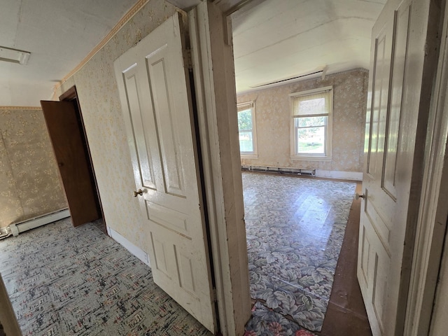 hall with a baseboard heating unit and wallpapered walls