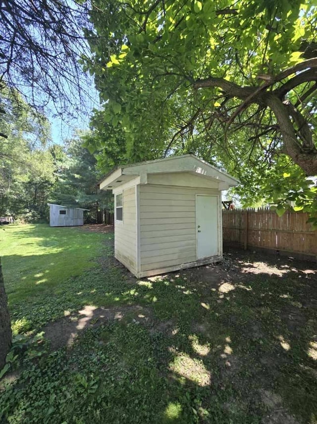 view of shed featuring fence