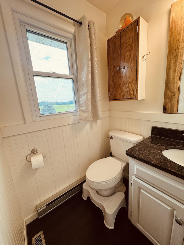 bathroom featuring vanity, a baseboard radiator, and toilet