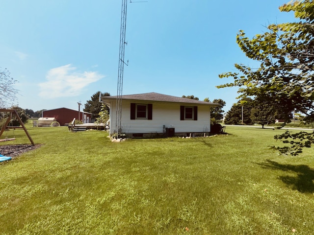 rear view of house featuring a yard and a playground