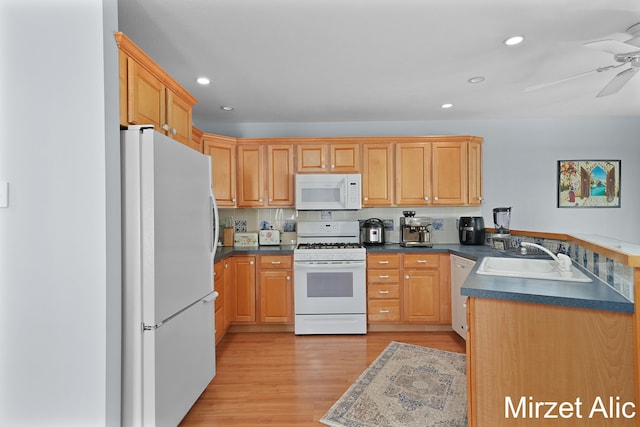 kitchen featuring white appliances, ceiling fan, sink, backsplash, and light hardwood / wood-style floors