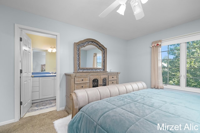 carpeted bedroom featuring connected bathroom and ceiling fan