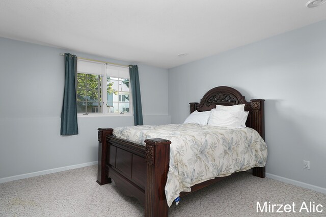 bedroom featuring light carpet