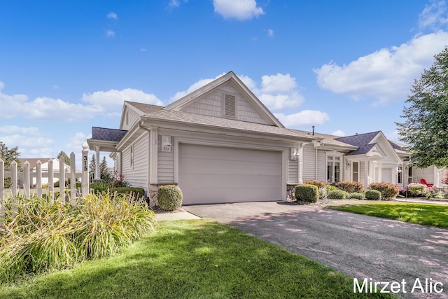 view of front of house with a garage and a front yard