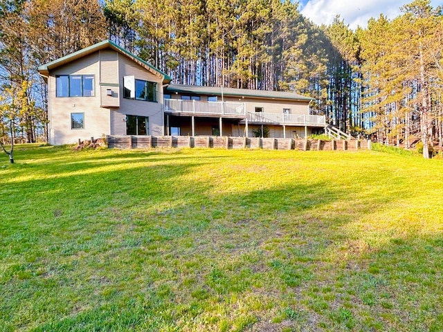 back of house featuring a deck and a yard