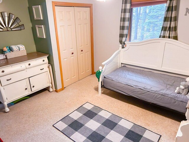 carpeted bedroom with a closet