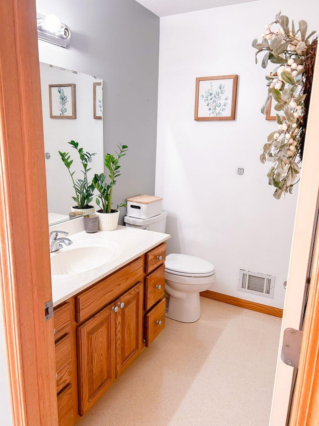 bathroom featuring toilet and vanity