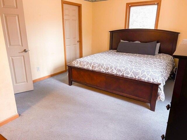 bedroom featuring light carpet