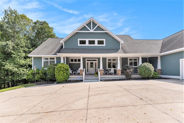 view of front facade with a porch and a shingled roof