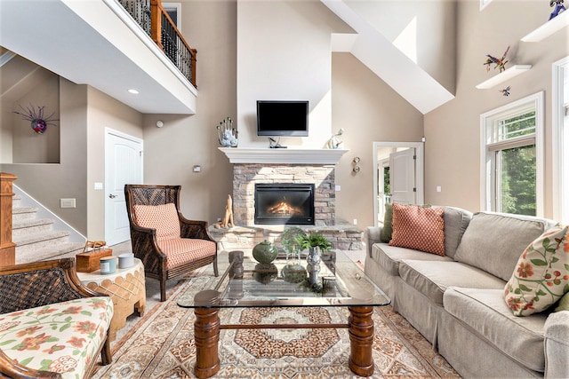 living room featuring a towering ceiling and a fireplace