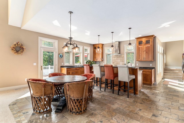 dining area featuring tile patterned floors and a chandelier