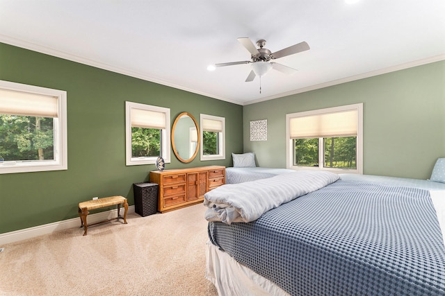 carpeted bedroom featuring ceiling fan and ornamental molding