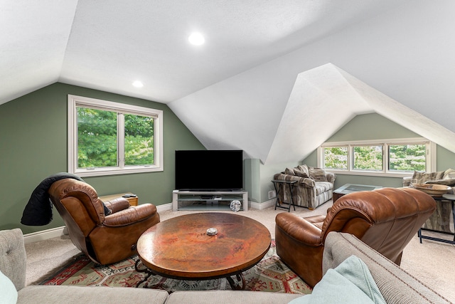 carpeted living room with lofted ceiling