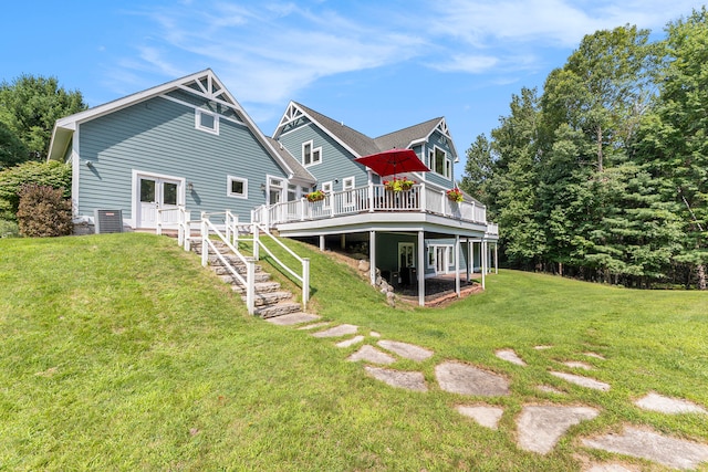 rear view of house with a yard and a deck