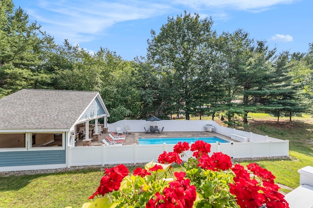 view of swimming pool featuring a patio and a yard