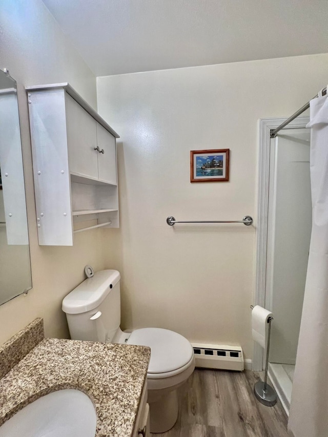 bathroom with a baseboard heating unit, walk in shower, toilet, hardwood / wood-style flooring, and vanity