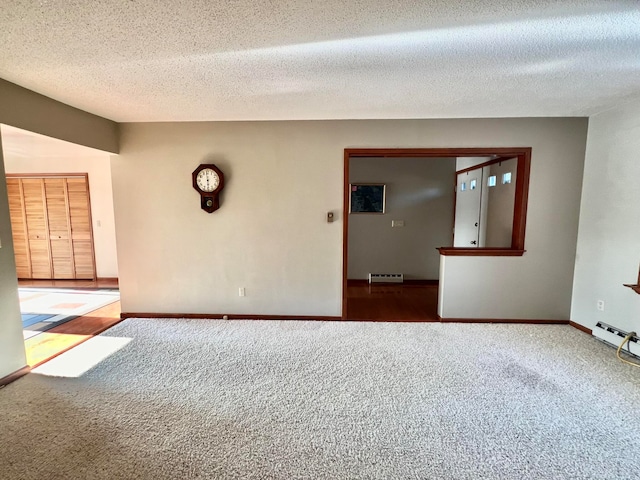 carpeted empty room featuring a textured ceiling