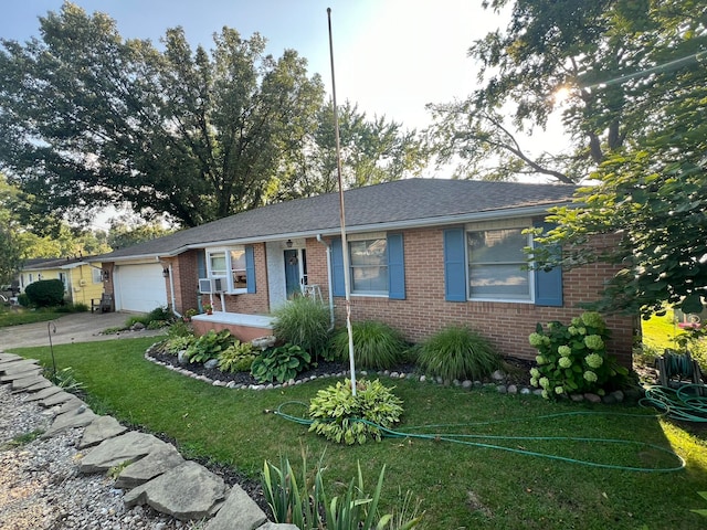 ranch-style home featuring a front lawn, cooling unit, and a garage