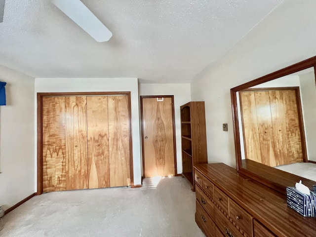 unfurnished bedroom featuring a textured ceiling and carpet