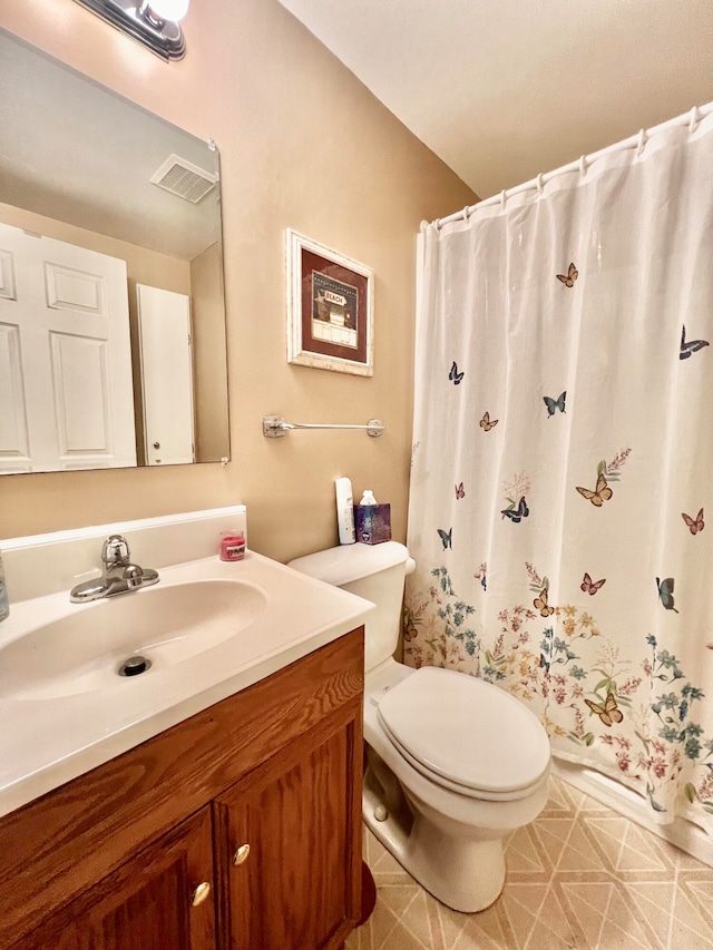 bathroom with vanity, tile patterned flooring, and toilet