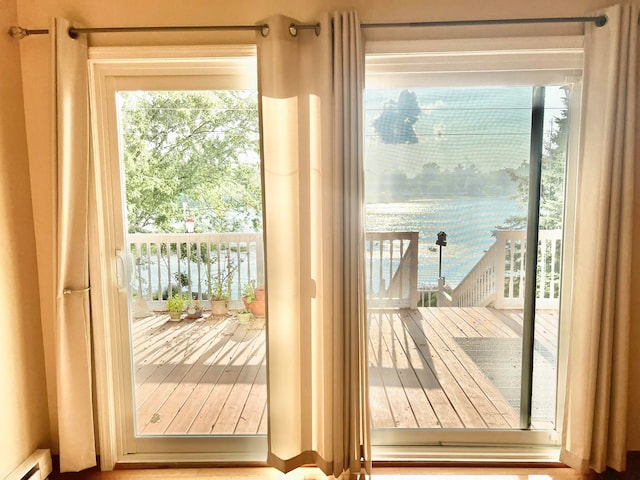 doorway to outside with a baseboard heating unit