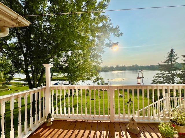 wooden terrace featuring a yard and a water view