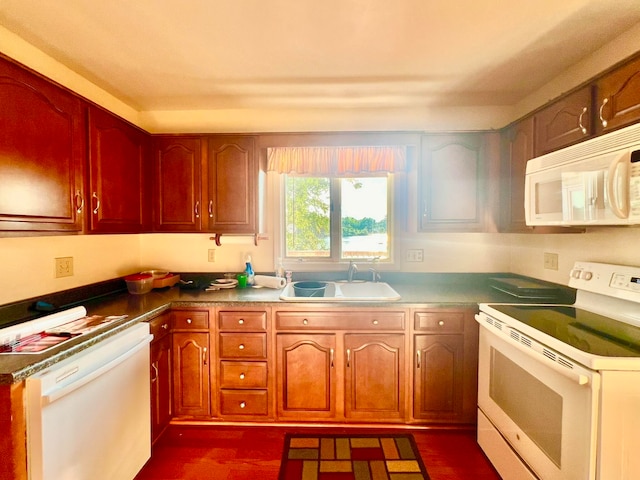 kitchen with dark hardwood / wood-style flooring, white appliances, and sink