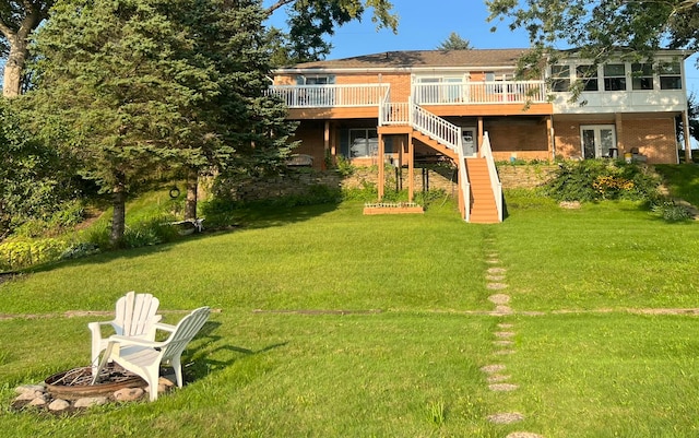 back of house featuring a yard and a wooden deck