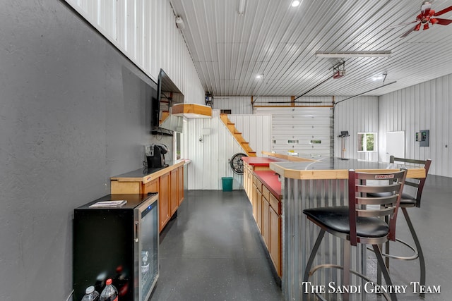 kitchen featuring a breakfast bar and ceiling fan