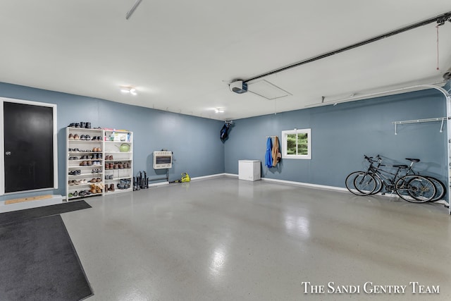 garage featuring a garage door opener and heating unit