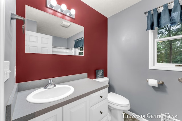 bathroom with a shower with curtain, vanity, and toilet