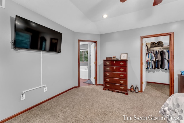 carpeted bedroom with a walk in closet, a closet, and ceiling fan