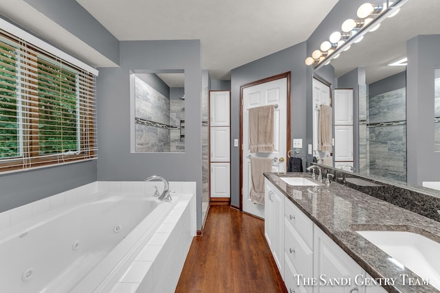 bathroom with separate shower and tub, vanity, and wood-type flooring