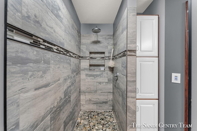 bathroom with a tile shower