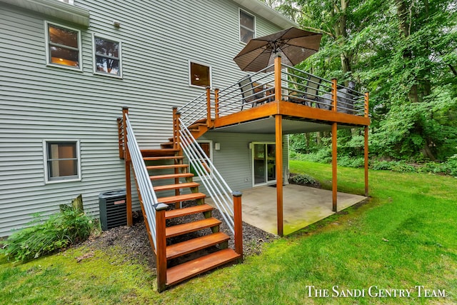 rear view of house featuring a yard, central air condition unit, a patio area, and a wooden deck